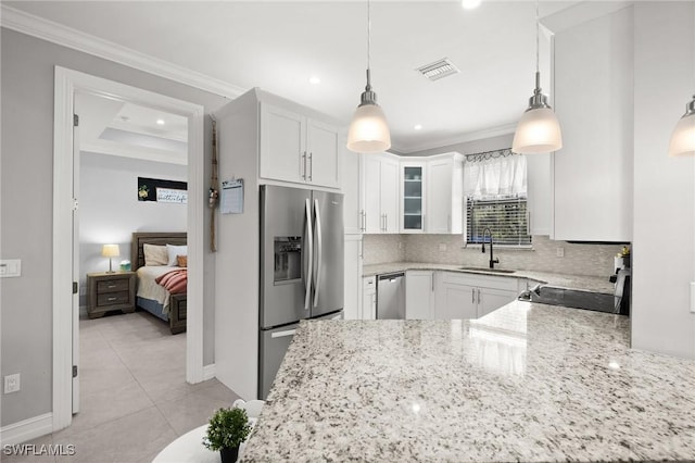 kitchen with white cabinetry, sink, decorative light fixtures, and appliances with stainless steel finishes