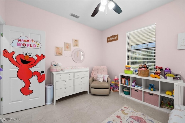 playroom with ceiling fan and light tile patterned flooring