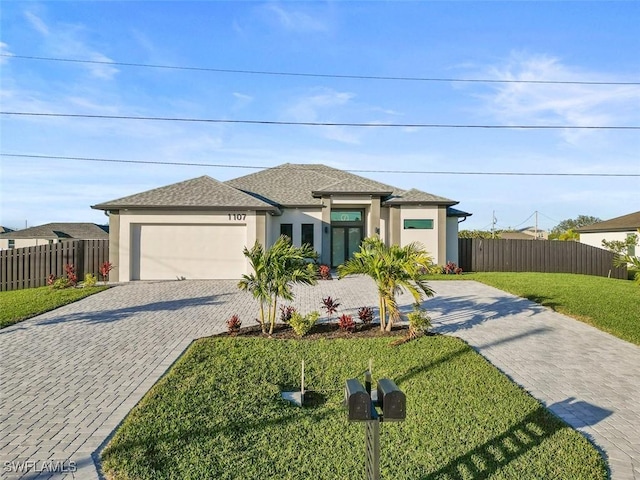 prairie-style home with a garage and a front lawn