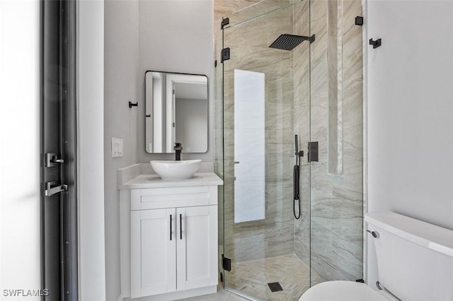 bathroom featuring vanity, toilet, and walk in shower