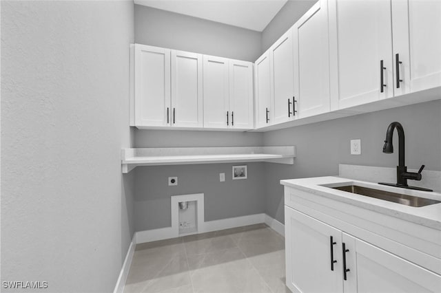 laundry room featuring sink, cabinets, washer hookup, hookup for an electric dryer, and light tile patterned floors