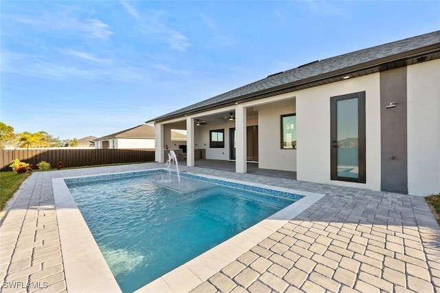 view of pool featuring ceiling fan, pool water feature, and a patio