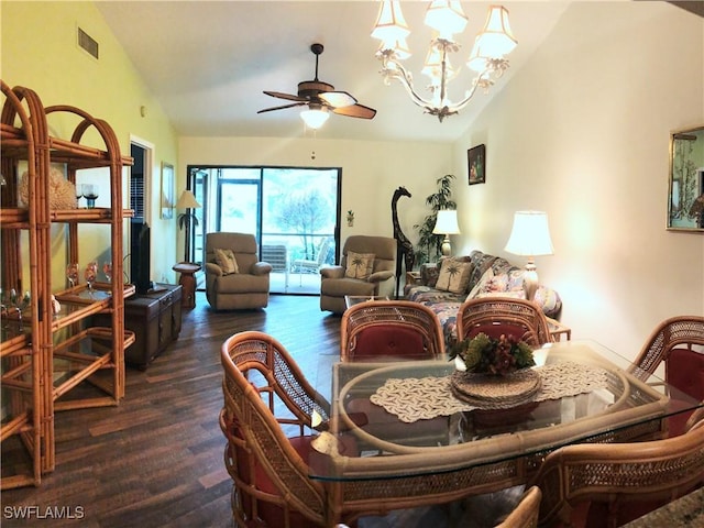 dining area featuring dark hardwood / wood-style flooring, ceiling fan with notable chandelier, and vaulted ceiling