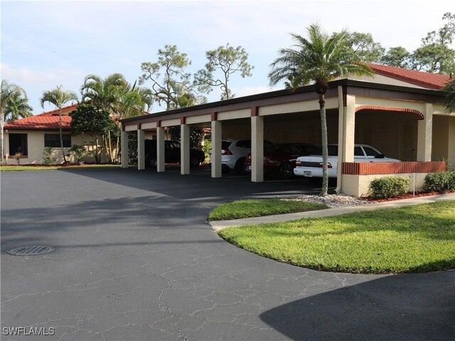 view of vehicle parking featuring a carport