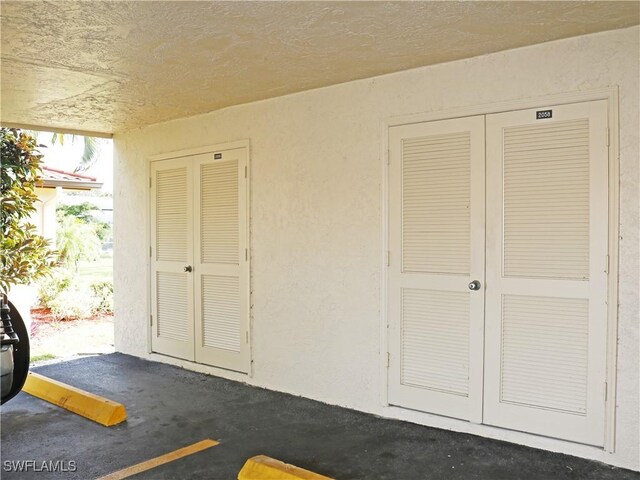 2056 Pine Isle Ln Unit 2056, Naples, FL 34112 - garage featuring a textured wall