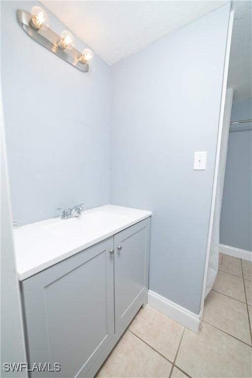 bathroom featuring tile patterned flooring and vanity