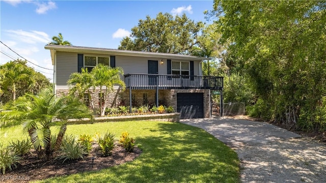 view of front of property featuring a garage and a front lawn