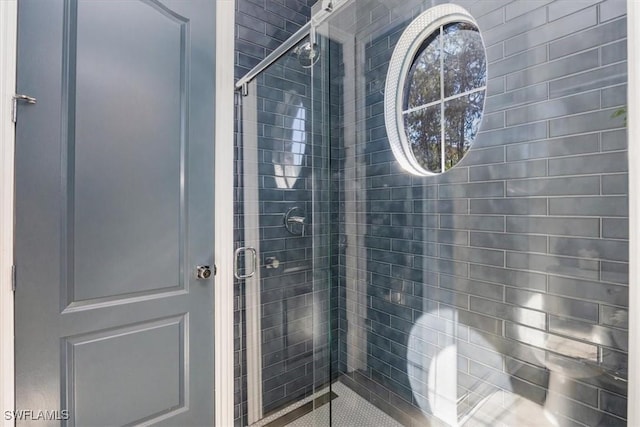 bathroom featuring a shower with shower door