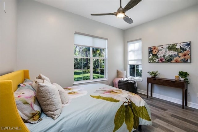 bedroom with dark hardwood / wood-style floors and ceiling fan