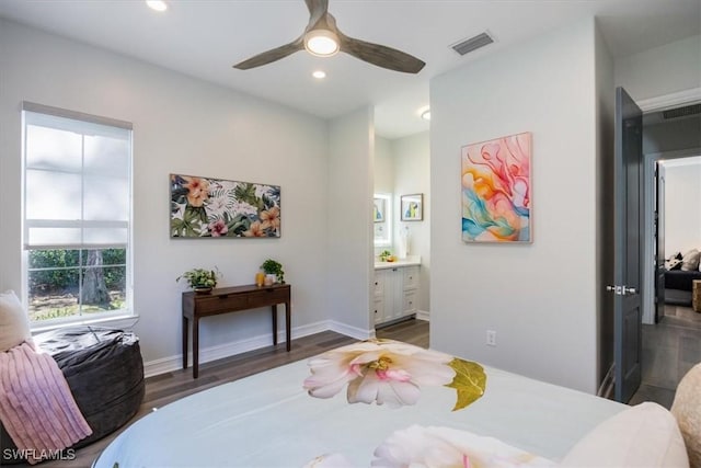 bedroom featuring ceiling fan, connected bathroom, and dark hardwood / wood-style flooring