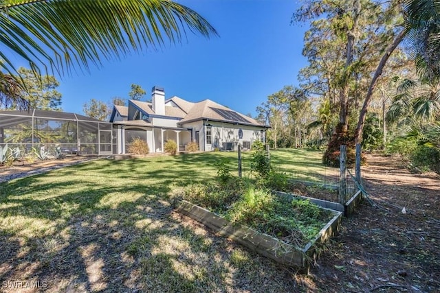 view of front facade featuring a lanai and a front lawn