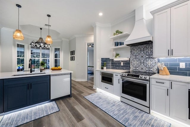 kitchen featuring custom exhaust hood, built in microwave, white dishwasher, stainless steel electric range oven, and pendant lighting