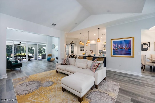 living room with high vaulted ceiling, hardwood / wood-style floors, and ceiling fan