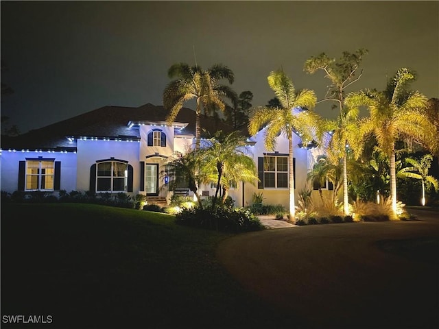 mediterranean / spanish house featuring a yard