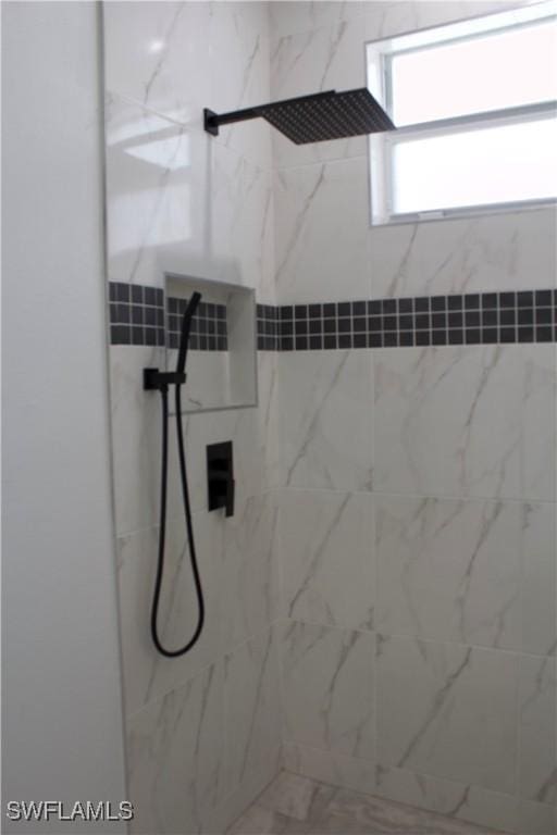 bathroom with tiled shower