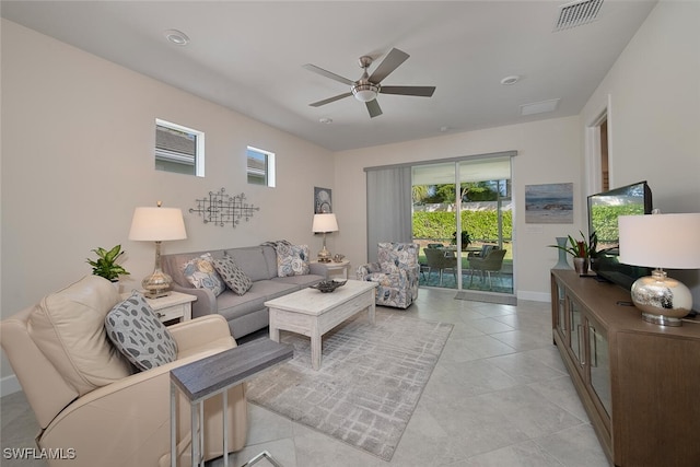 tiled living room with ceiling fan