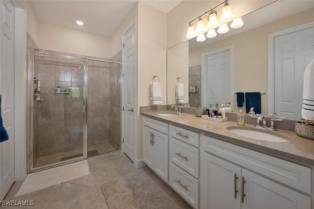 bathroom with vanity, tile patterned floors, and a shower with shower door