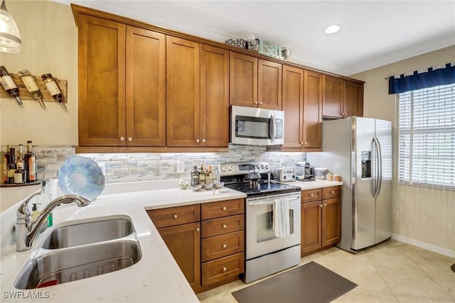 kitchen featuring light stone countertops, backsplash, stainless steel appliances, sink, and light tile patterned flooring