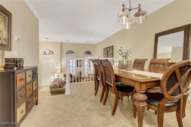 tiled dining room with an inviting chandelier and crown molding