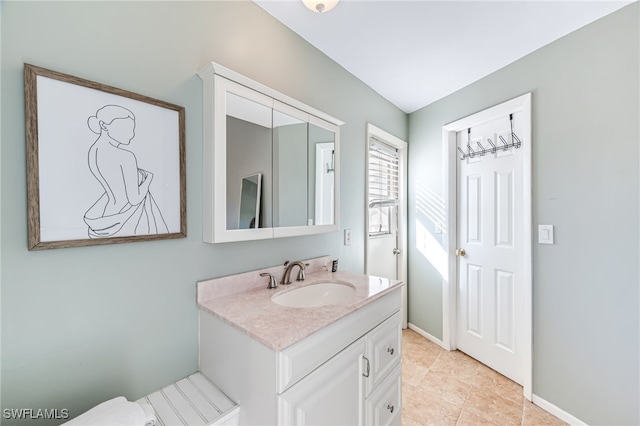 bathroom with tile patterned floors and vanity