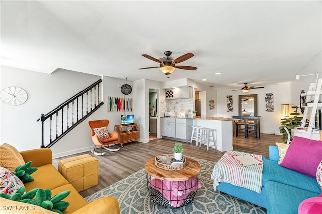 living room with ceiling fan and dark wood-type flooring