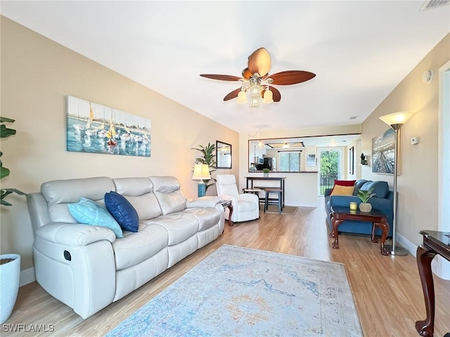 living room featuring hardwood / wood-style flooring and ceiling fan