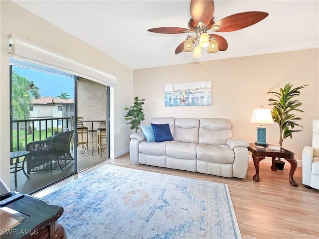 living room featuring light hardwood / wood-style floors and ceiling fan