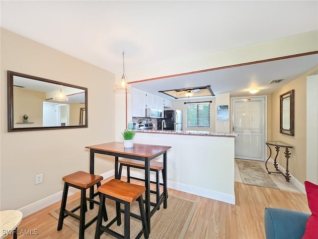 dining area with light wood-type flooring