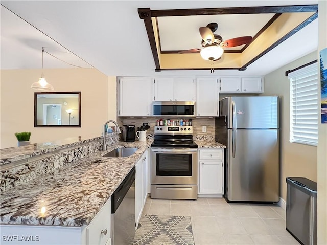 kitchen with light stone countertops, sink, white cabinets, and stainless steel appliances