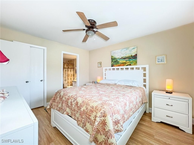 bedroom featuring ceiling fan, light wood-type flooring, and ensuite bathroom