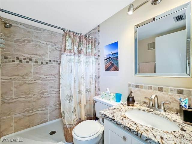 bathroom featuring backsplash, a shower with curtain, vanity, and toilet