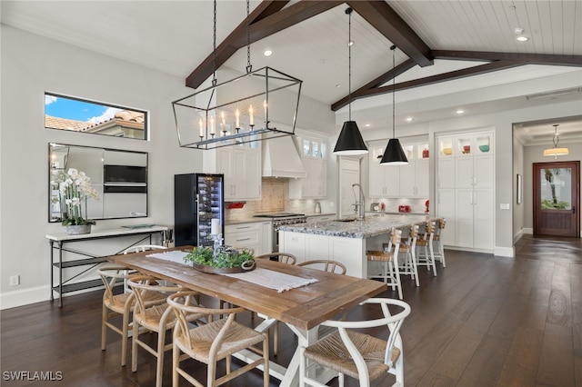 dining area with lofted ceiling with beams, sink, an inviting chandelier, dark wood-type flooring, and wood ceiling