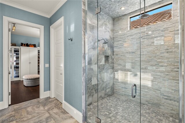 bathroom with crown molding and walk in shower