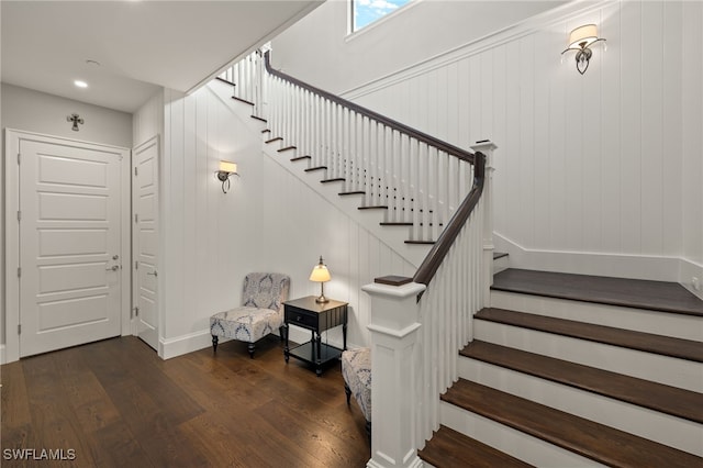 staircase with hardwood / wood-style floors