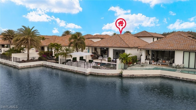 view of pool with a water view and a patio