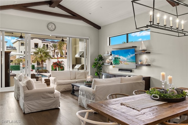 sunroom / solarium featuring a healthy amount of sunlight, lofted ceiling with beams, ceiling fan with notable chandelier, and wooden ceiling