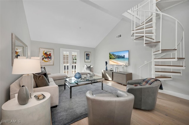 living room with french doors, stairway, wood finished floors, and visible vents