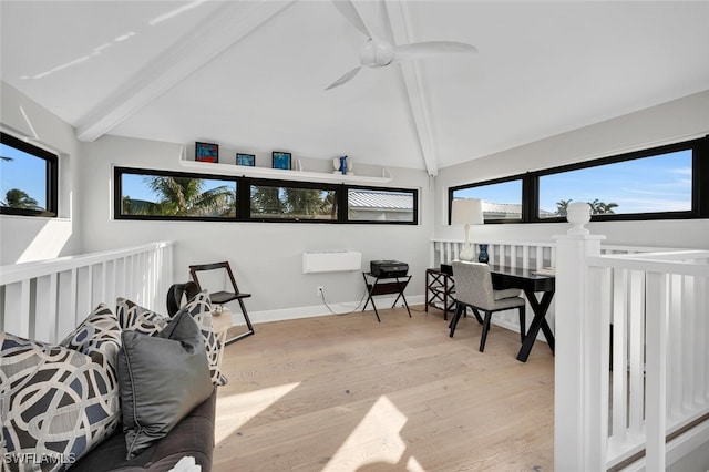 interior space with a ceiling fan and vaulted ceiling with beams