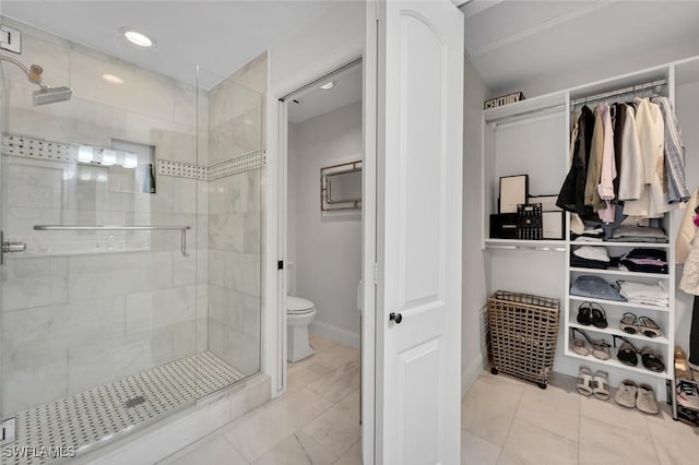 full bath with a stall shower, toilet, and baseboards