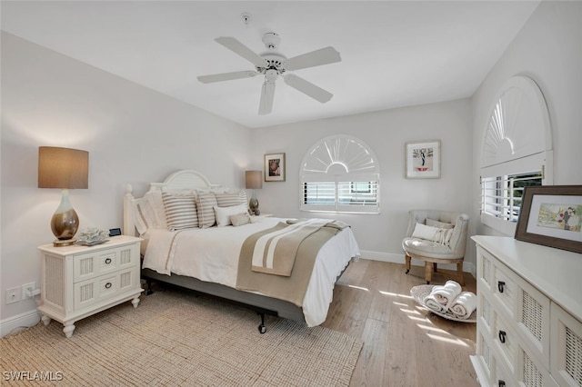 bedroom featuring multiple windows, ceiling fan, and light hardwood / wood-style floors