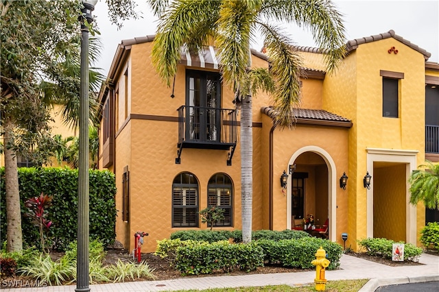 mediterranean / spanish home featuring a balcony