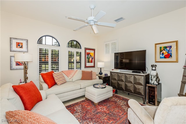 living room featuring ceiling fan and wine cooler