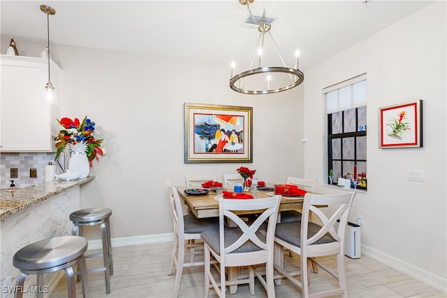 dining space featuring an inviting chandelier