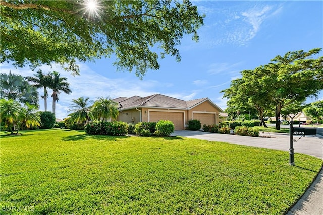 single story home featuring a garage and a front lawn