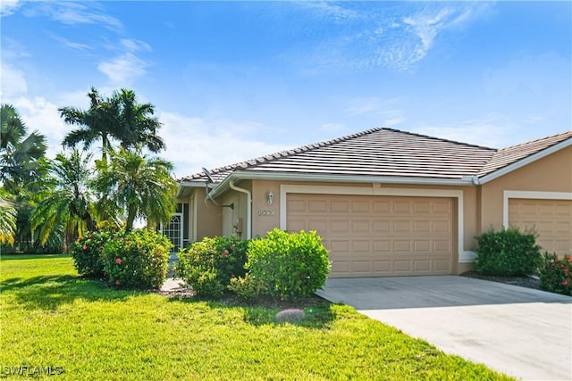 ranch-style home with a front yard and a garage