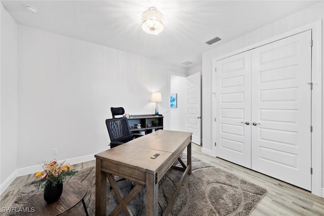 office with light wood-type flooring