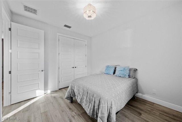 bedroom featuring wood-type flooring and a closet