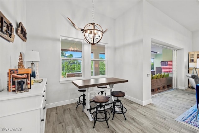 dining room featuring light hardwood / wood-style flooring and a notable chandelier