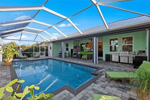 view of swimming pool with outdoor lounge area, an outdoor kitchen, a lanai, grilling area, and a patio