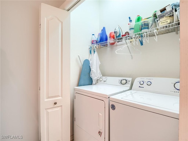 clothes washing area with washer and clothes dryer